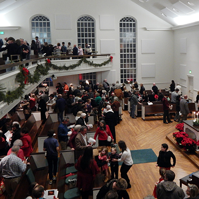 the congregation gathers and enjoys fellowship after a Lovefeast Christmas service