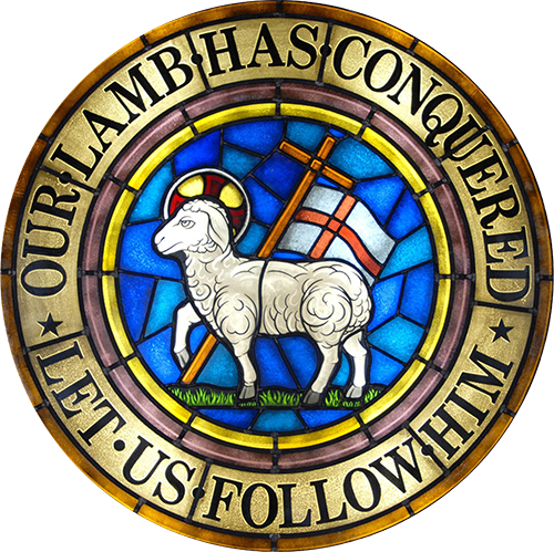 stained glass presentation of the Moravian seal that reads, "Our lamb has conquered. Let us follow him."