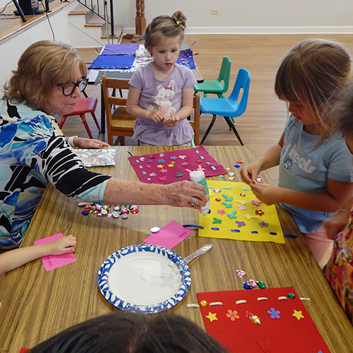 children being led in Godly play during Sunday worship service