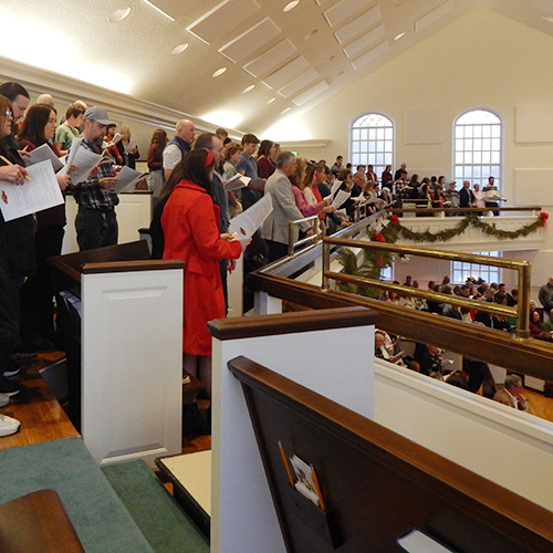 Lovefeast attendees stand to sing for the prelude