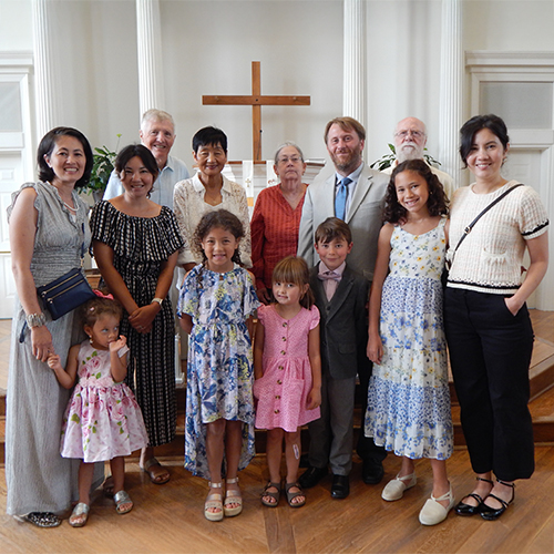 A family is welcomed into the church after joining KMC